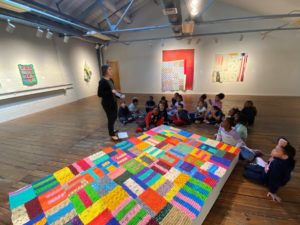Children at Artspace looking at large colorful artwork