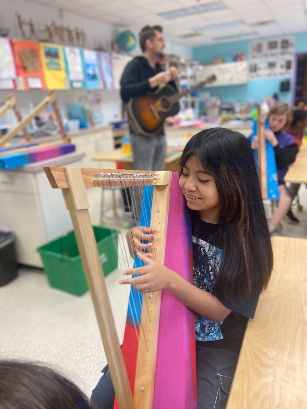 Girl with harp she created at Powell Magnet Elementary