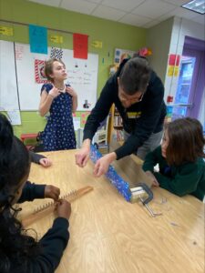 Joe helps Student with harp